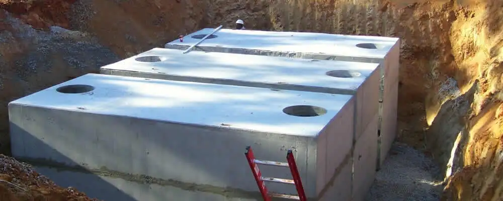 Septic tank installation site with a newly placed concrete tank in Burlington, VT